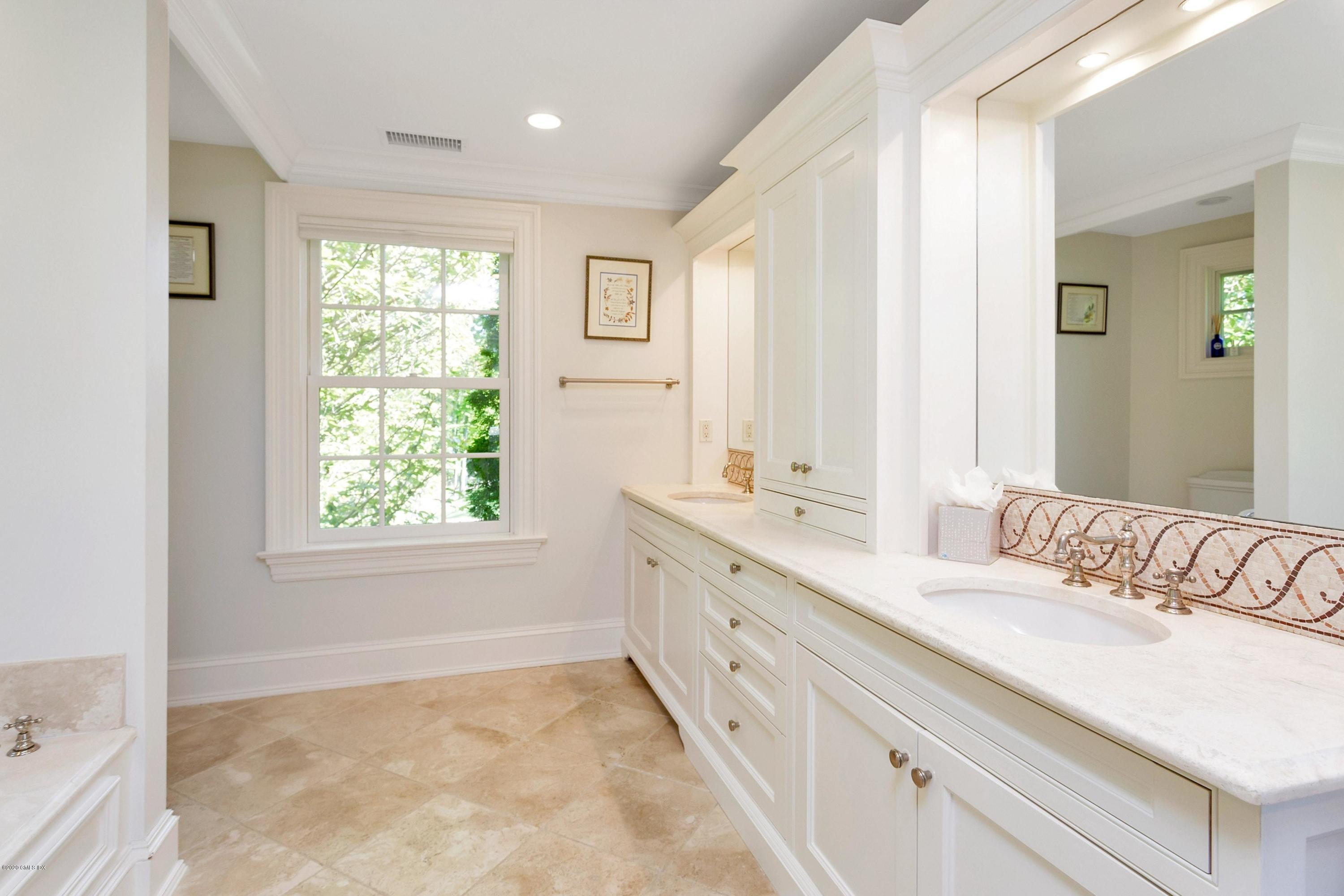 122 Butternut Hollow Road Greenwich, CT 06830 - Photo 22 of 36 a spacious bathroom with double vanity and a mirror