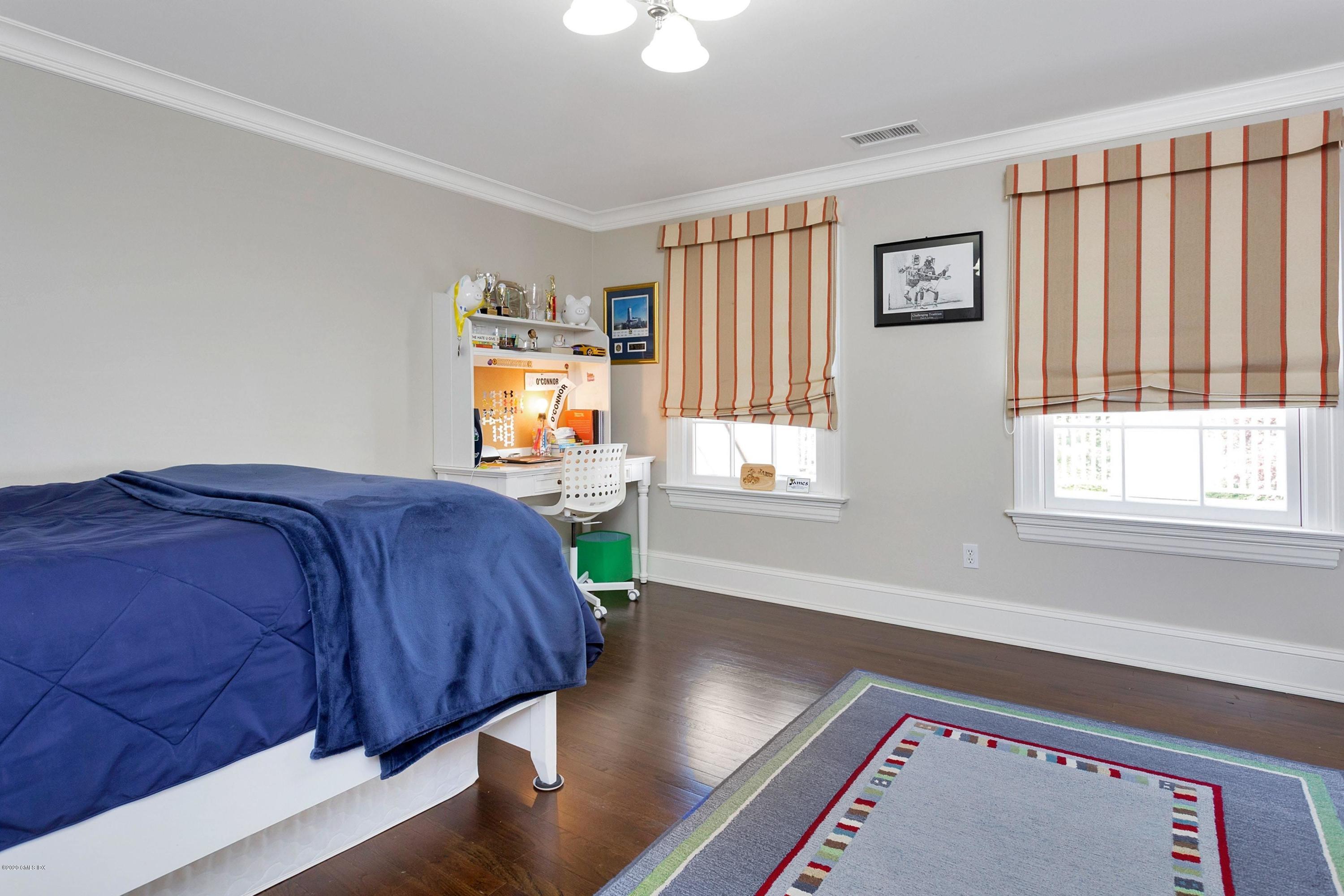 122 Butternut Hollow Road Greenwich, CT 06830 - Photo 25 of 36 a spacious bedroom with a bed and wooden floor