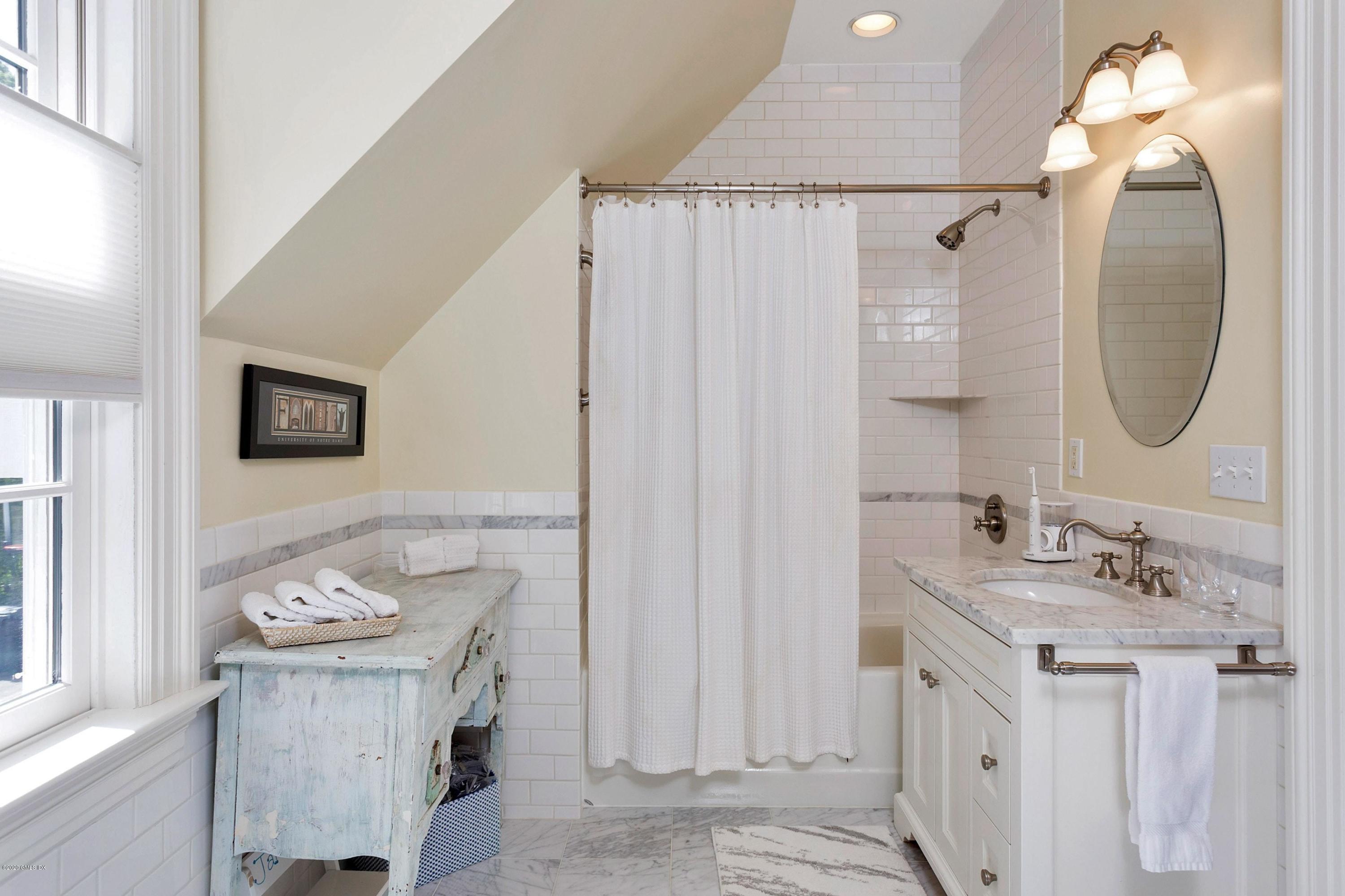 122 Butternut Hollow Road Greenwich, CT 06830 - Photo 28 of 36 a bathroom with a sink vanity and a mirror