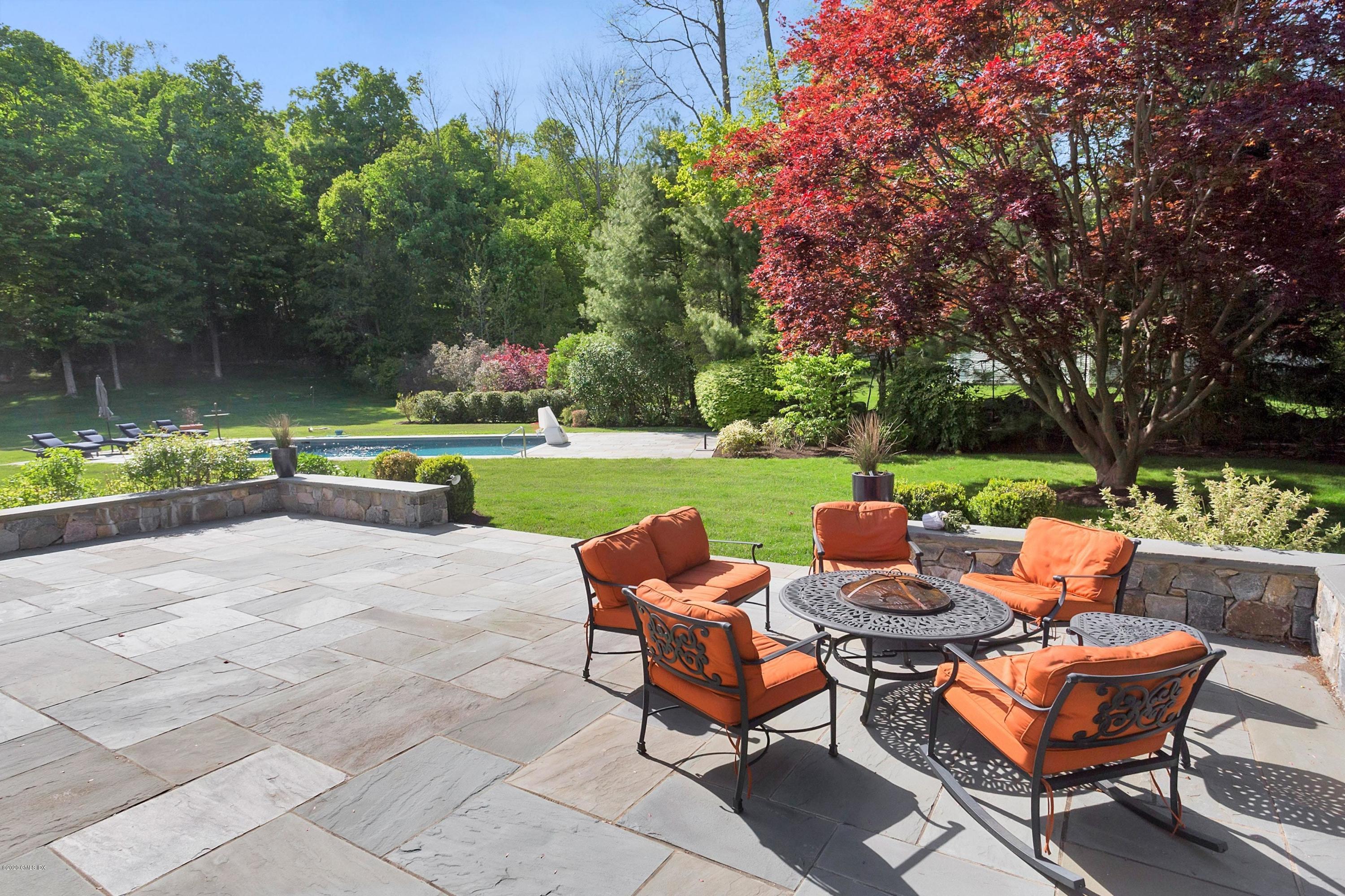 122 Butternut Hollow Road Greenwich, CT 06830 - Photo 30 of 36 a view of a patio with chairs and table in a yard