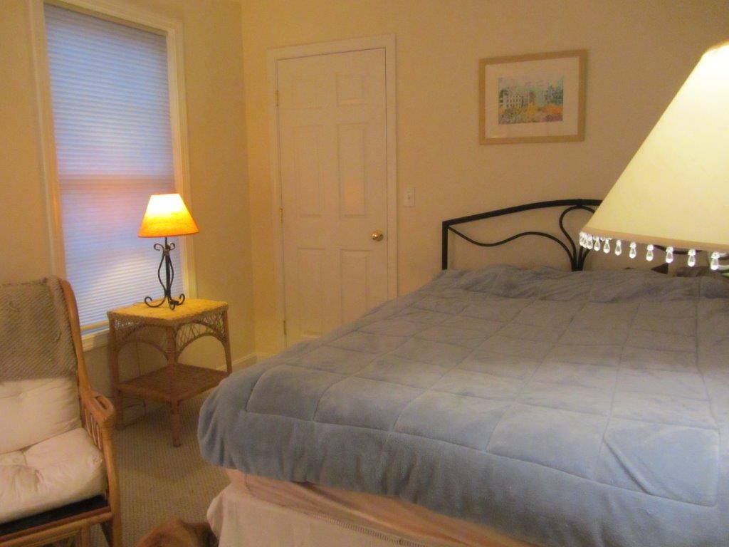 1161 B Mammoth Road, Unit B Pelham, NH 03076 - Photo 11 of 14 a bedroom with a bed and a lamp