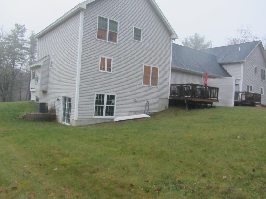 1161 B Mammoth Road, Unit B Pelham, NH 03076 - Photo 2 of 14 a view of a house with a yard