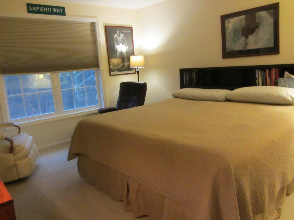 1161 B Mammoth Road, Unit B Pelham, NH 03076 - Photo 9 of 14 a bedroom with a bed and cupboard