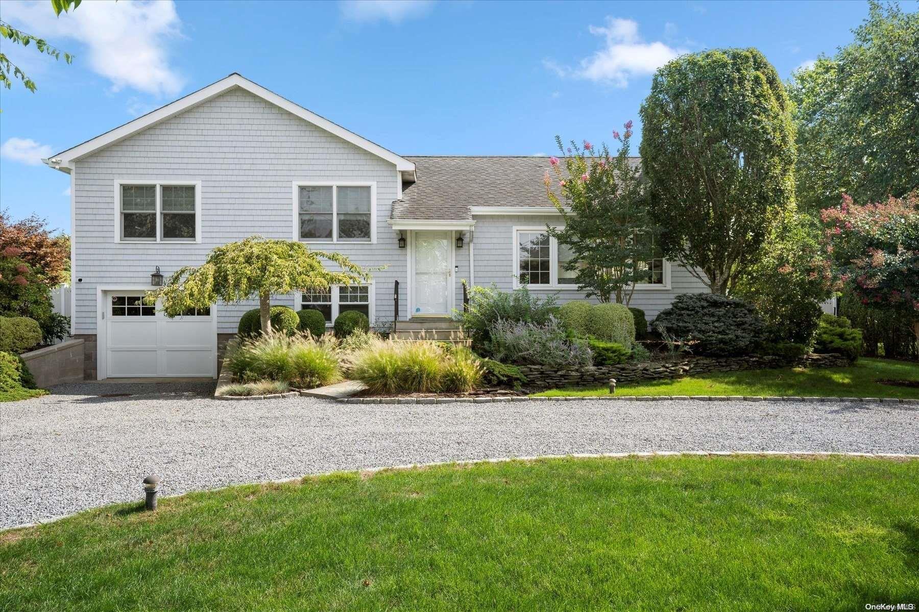 11 Tuttle Place Westhampton Beach, NY 11978 - Photo 1 of 1 a front view of a house with a yard and potted plants