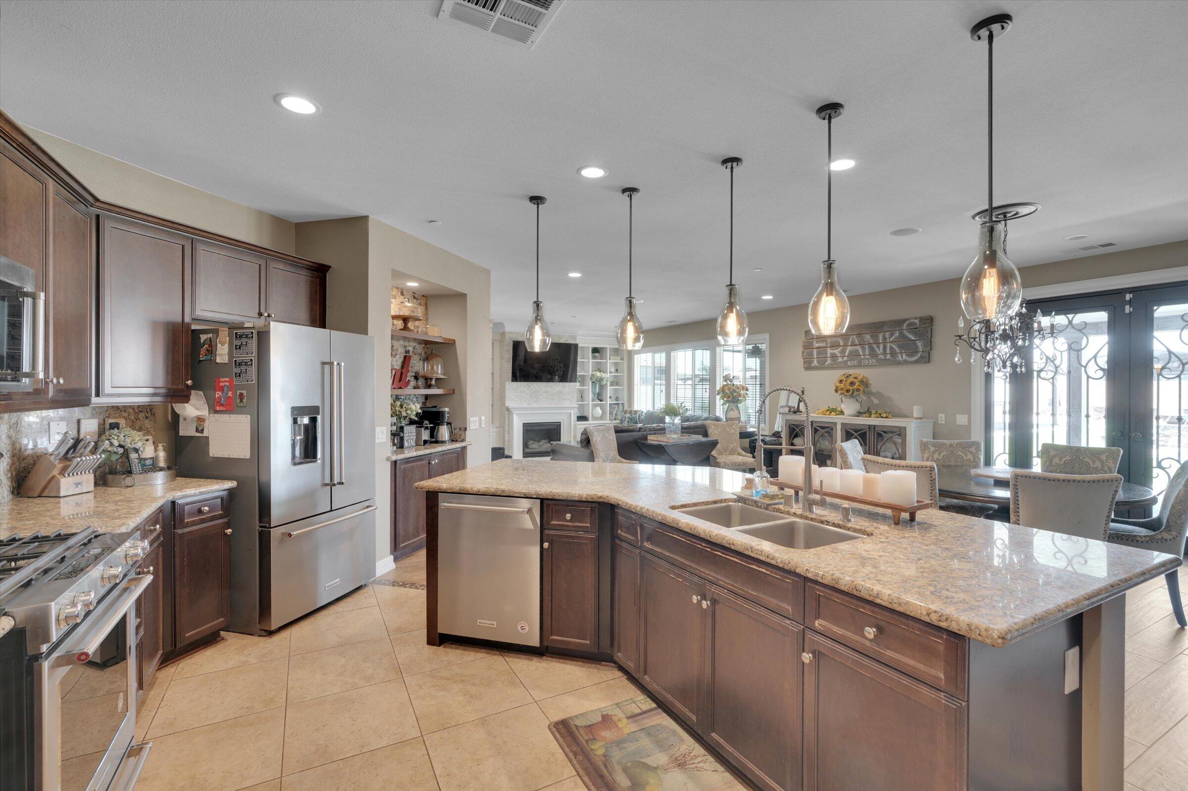 1635 Whitlatch Drive Lancaster, CA 93535 - Photo 11 of 58 a kitchen with granite countertop a sink appliances cabinets and furniture