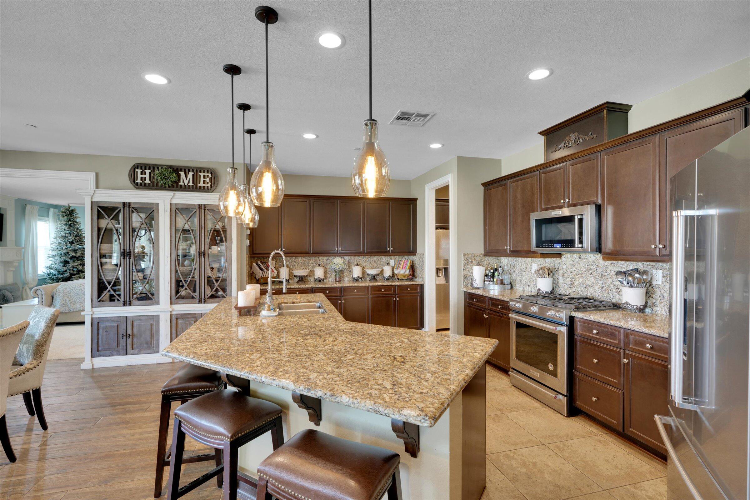 1635 Whitlatch Drive Lancaster, CA 93535 - Photo 13 of 58 a large kitchen with a table and chairs