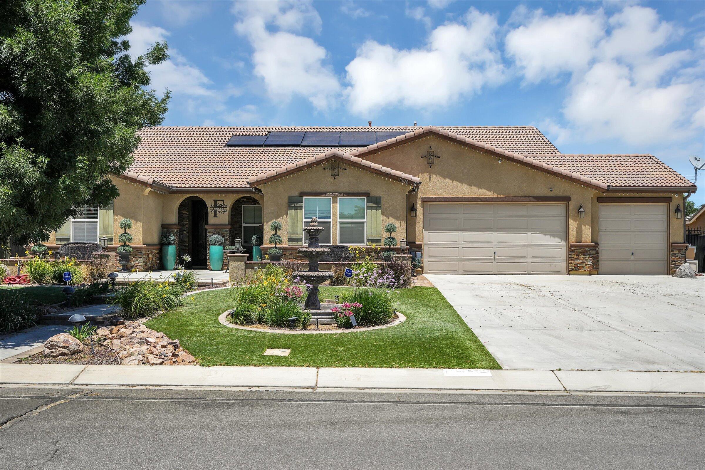 1635 Whitlatch Drive Lancaster, CA 93535 - Photo 2 of 58 a front view of a house with a yard fire pit and outdoor seating