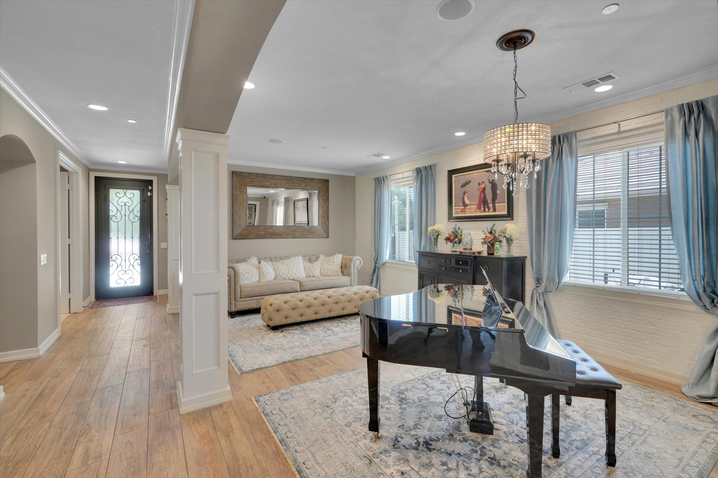 1635 Whitlatch Drive Lancaster, CA 93535 - Photo 23 of 58 a living room with furniture a window and a chandelier