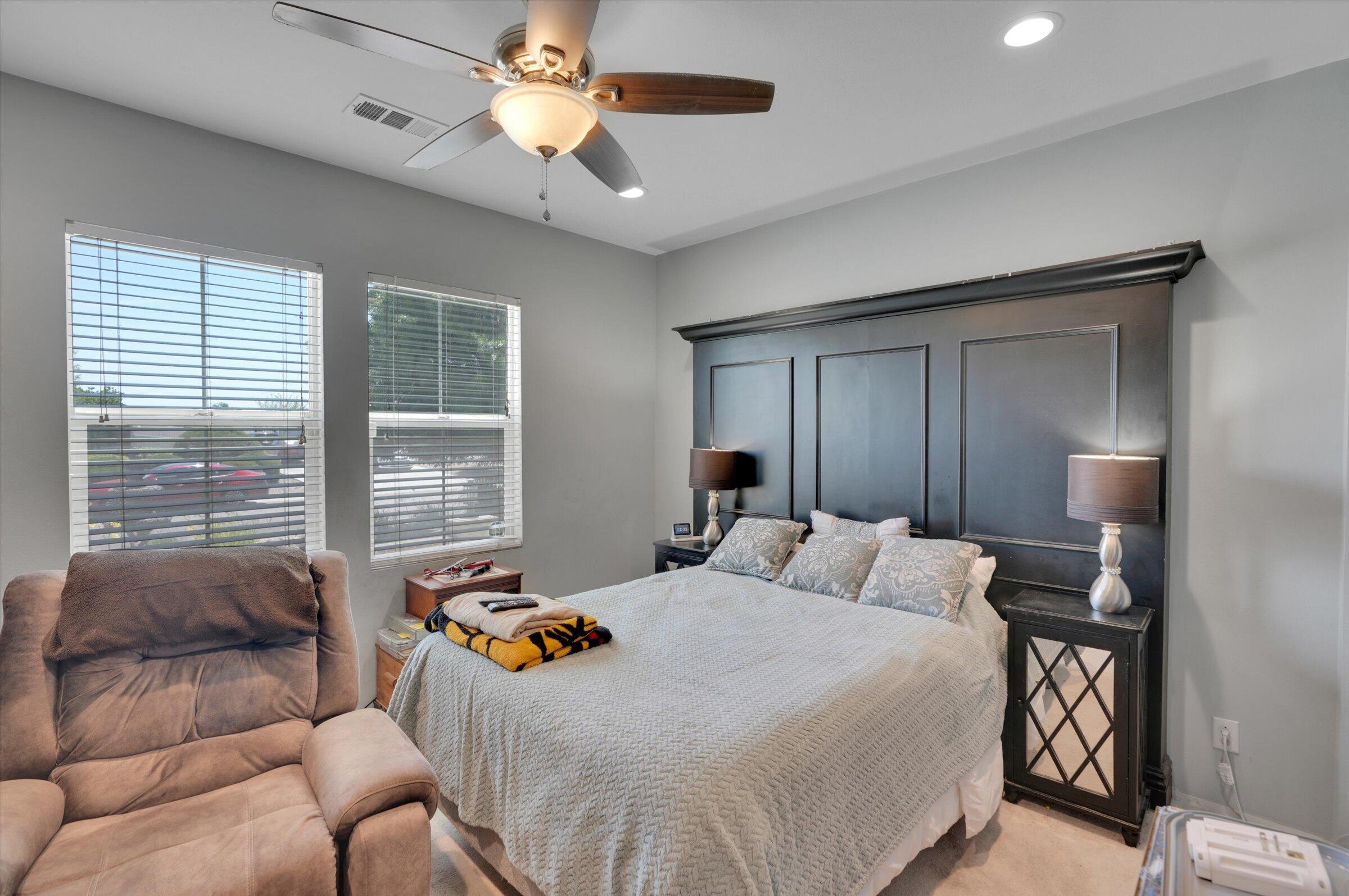 1635 Whitlatch Drive Lancaster, CA 93535 - Photo 39 of 58 a bedroom with a bed a chandelier and a window