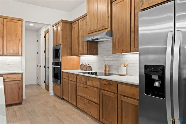 a kitchen with stainless steel appliances a refrigerator and a sink