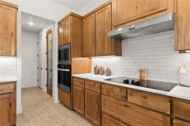 a kitchen with stainless steel appliances a refrigerator and a sink