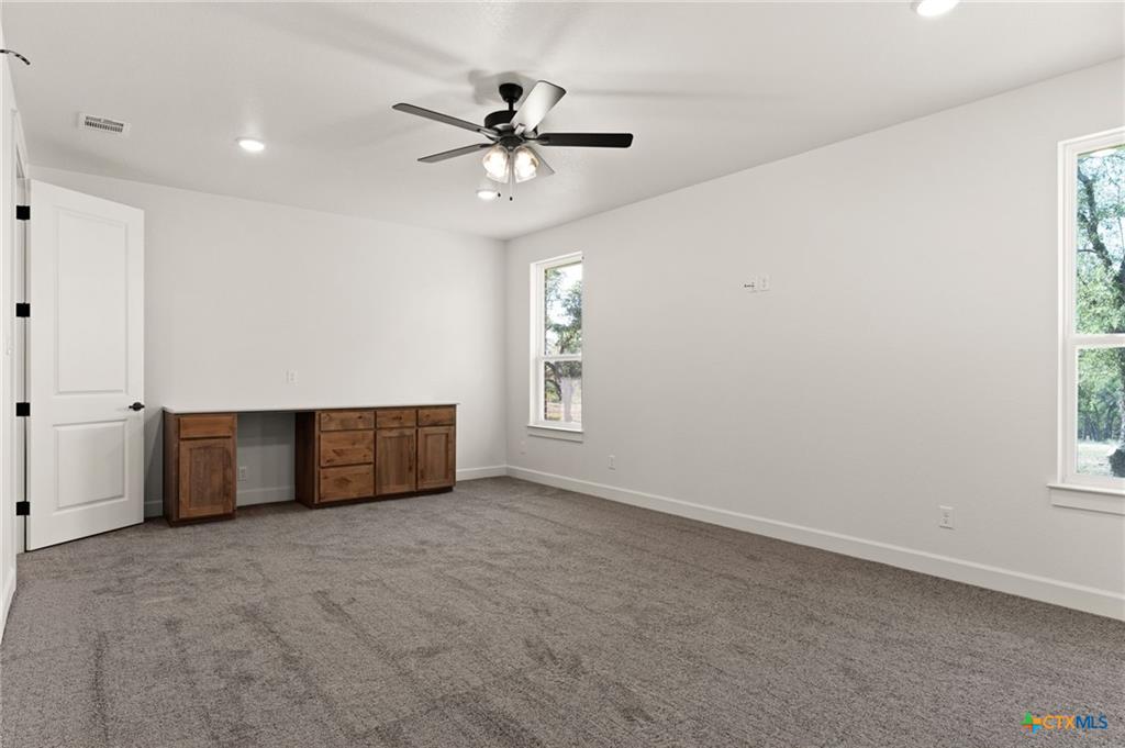 4237 Cold Springs Road Kempner, TX 76539 - Photo 23 of 33 Empty room with light colored carpet, recessed lighting, ceiling fan, and built in desk