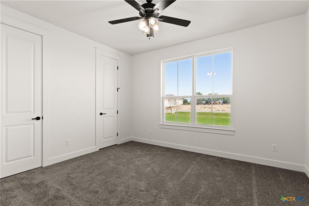 4237 Cold Springs Road Kempner, TX 76539 - Photo 27 of 33 Unfurnished bedroom featuring dark carpet and ceiling fan