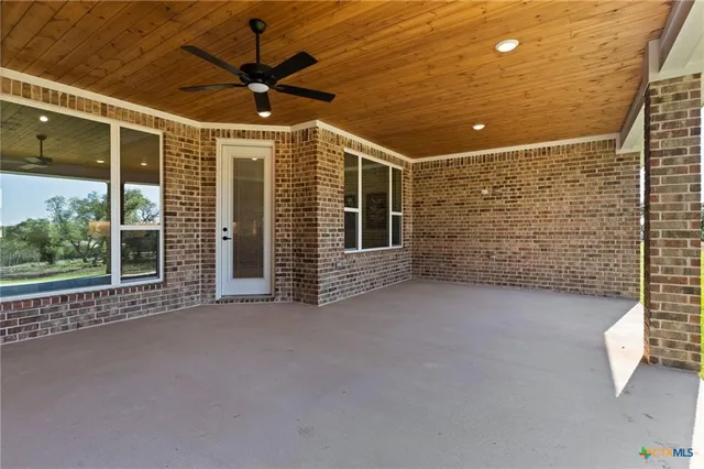 a view of a livingroom with a ceiling fan and window