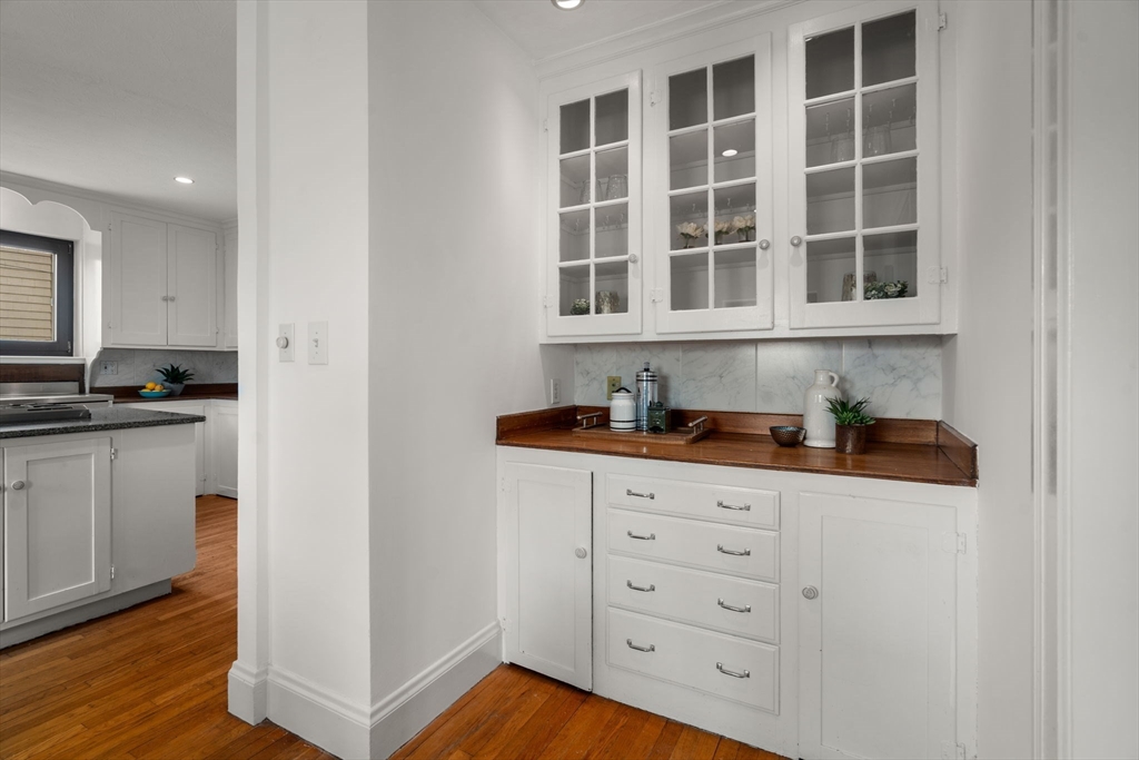 110 Wallis Road Chestnut Hill, MA 02467 - Photo 7 of 29 a kitchen with granite countertop white cabinets and sink