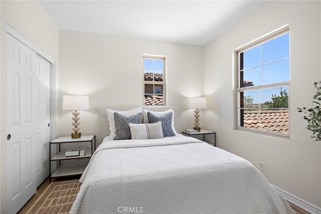 47 Tuscany Ladera Ranch, CA 92694 - Photo 19 of 28 a bedroom with a bed and a night stand