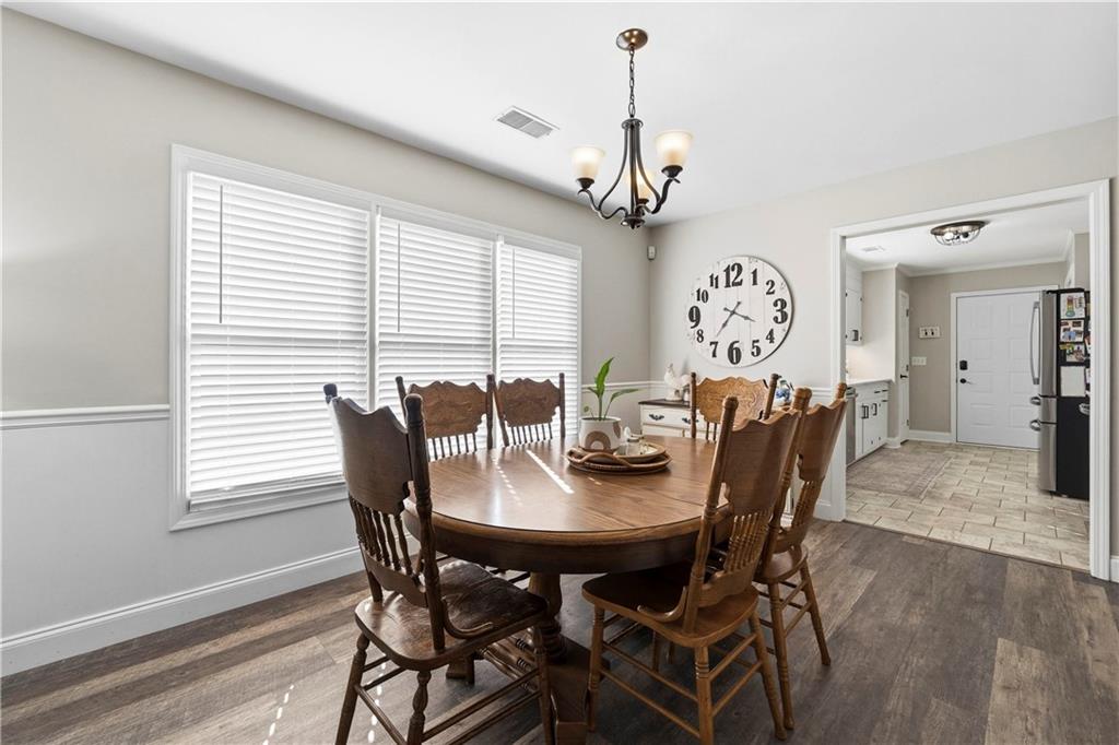 2777 Chickadee Drive Monroe, GA 30655 - Photo 21 of 36 a view of a dining room with furniture window and wooden floor
