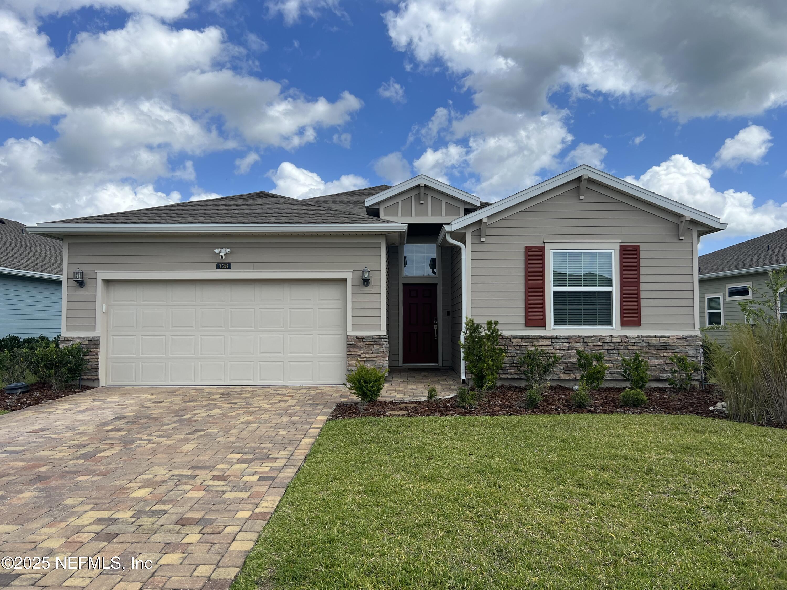 a front view of a house with a garden