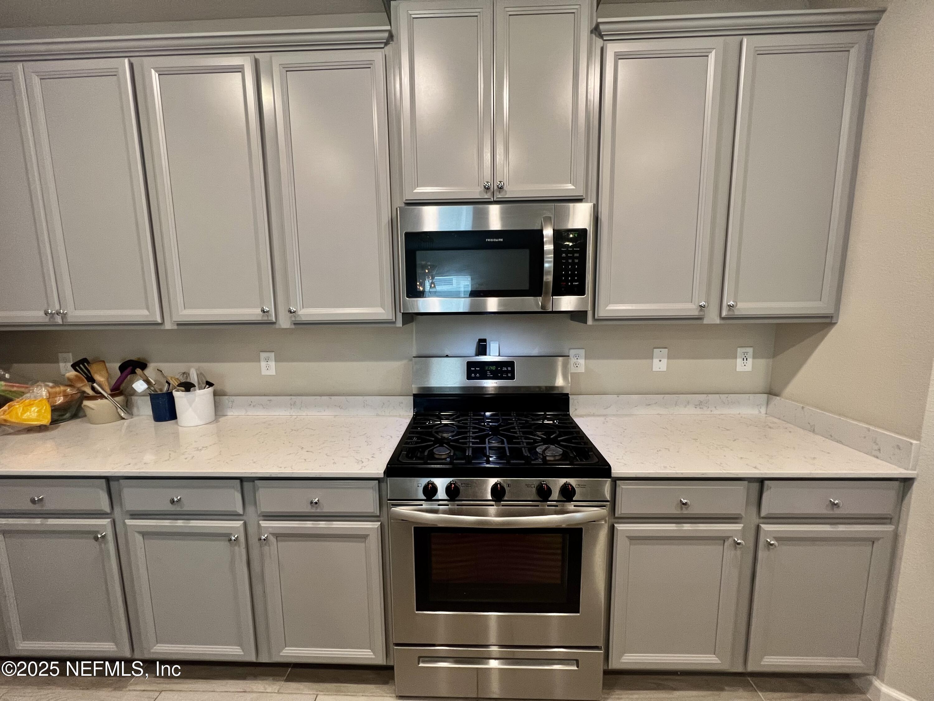 128 Ash Breeze Cove St. Augustine, FL 32095 - Photo 11 of 57 a kitchen with granite countertop white cabinets and white appliances