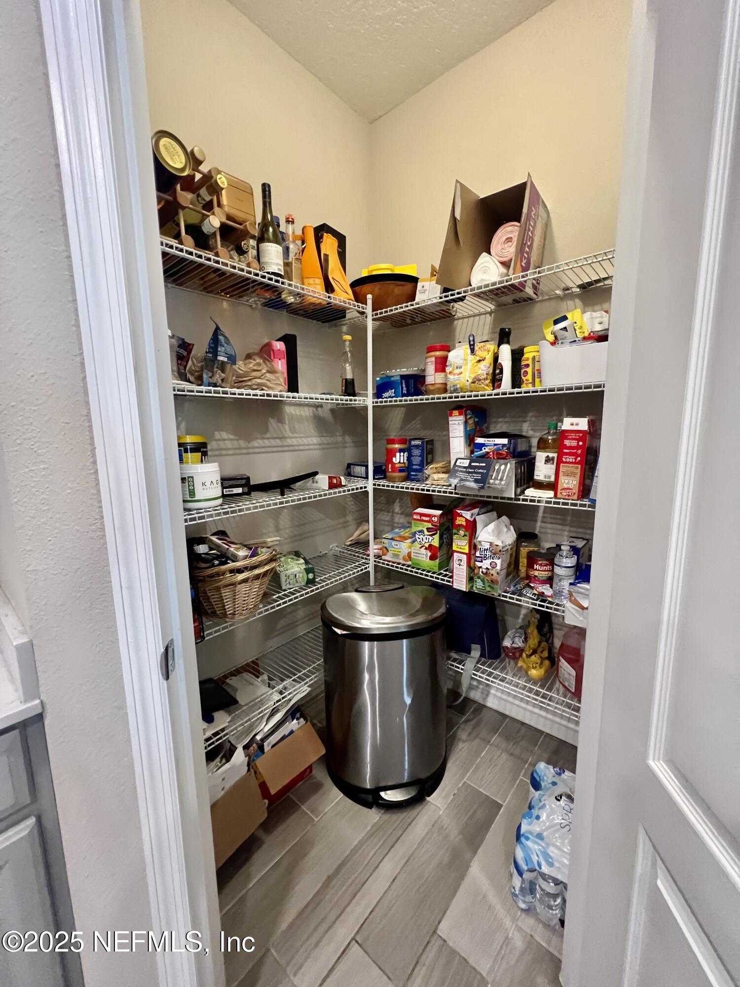 128 Ash Breeze Cove St. Augustine, FL 32095 - Photo 12 of 57 a room with a wooden floor and shelf