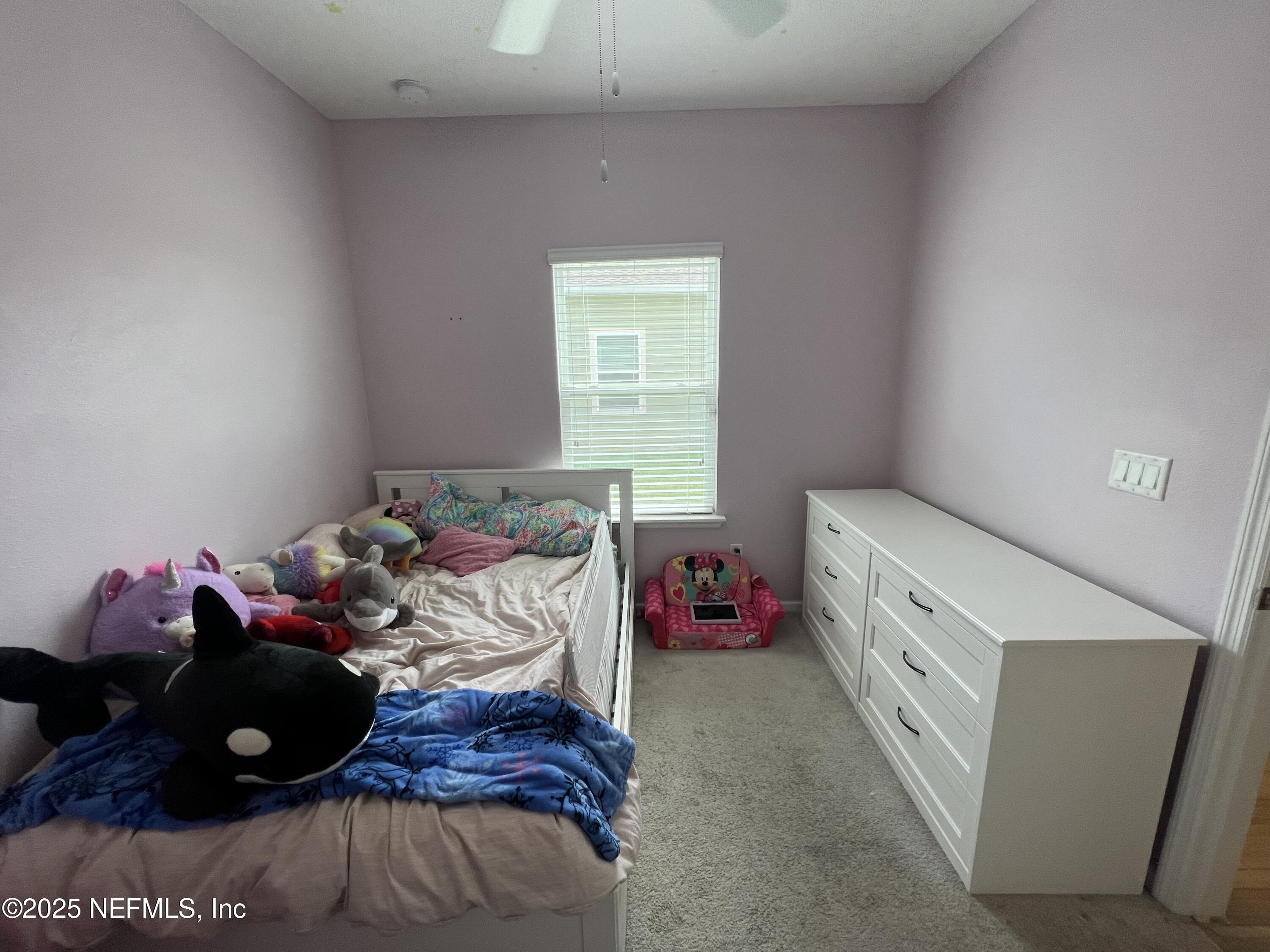 128 Ash Breeze Cove St. Augustine, FL 32095 - Photo 18 of 57 a bedroom with a bed and a window