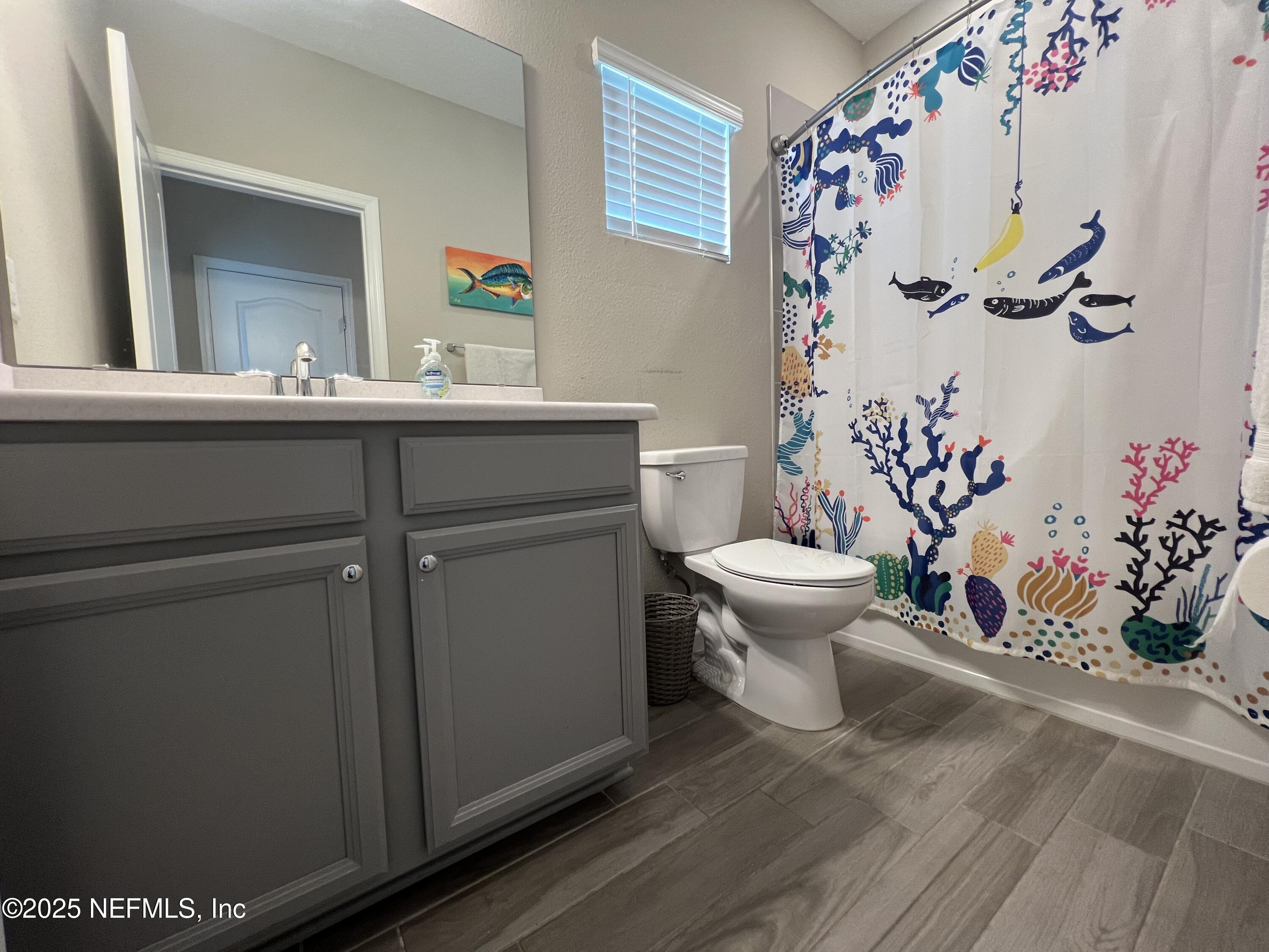128 Ash Breeze Cove St. Augustine, FL 32095 - Photo 19 of 57 a bathroom with a sink mirror and toilet