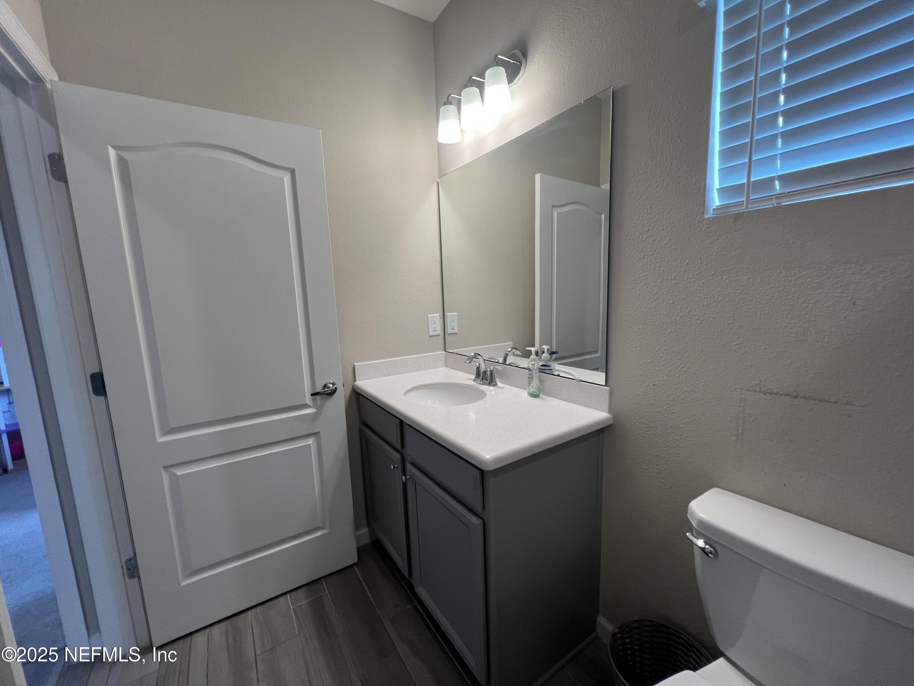 128 Ash Breeze Cove St. Augustine, FL 32095 - Photo 20 of 57 a bathroom with a sink toilet and mirror