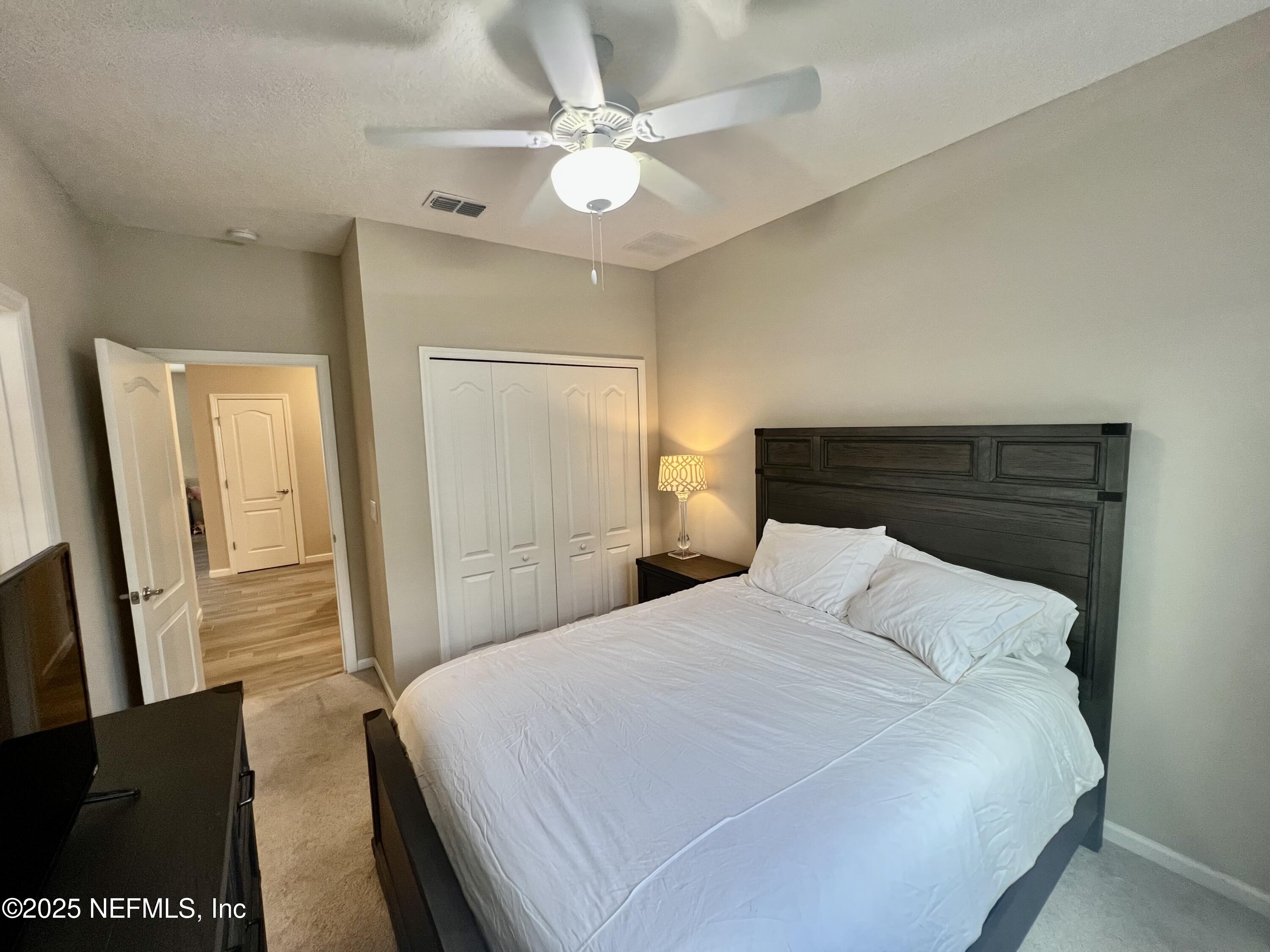 128 Ash Breeze Cove St. Augustine, FL 32095 - Photo 26 of 57 a bedroom with a bed and a flat screen tv