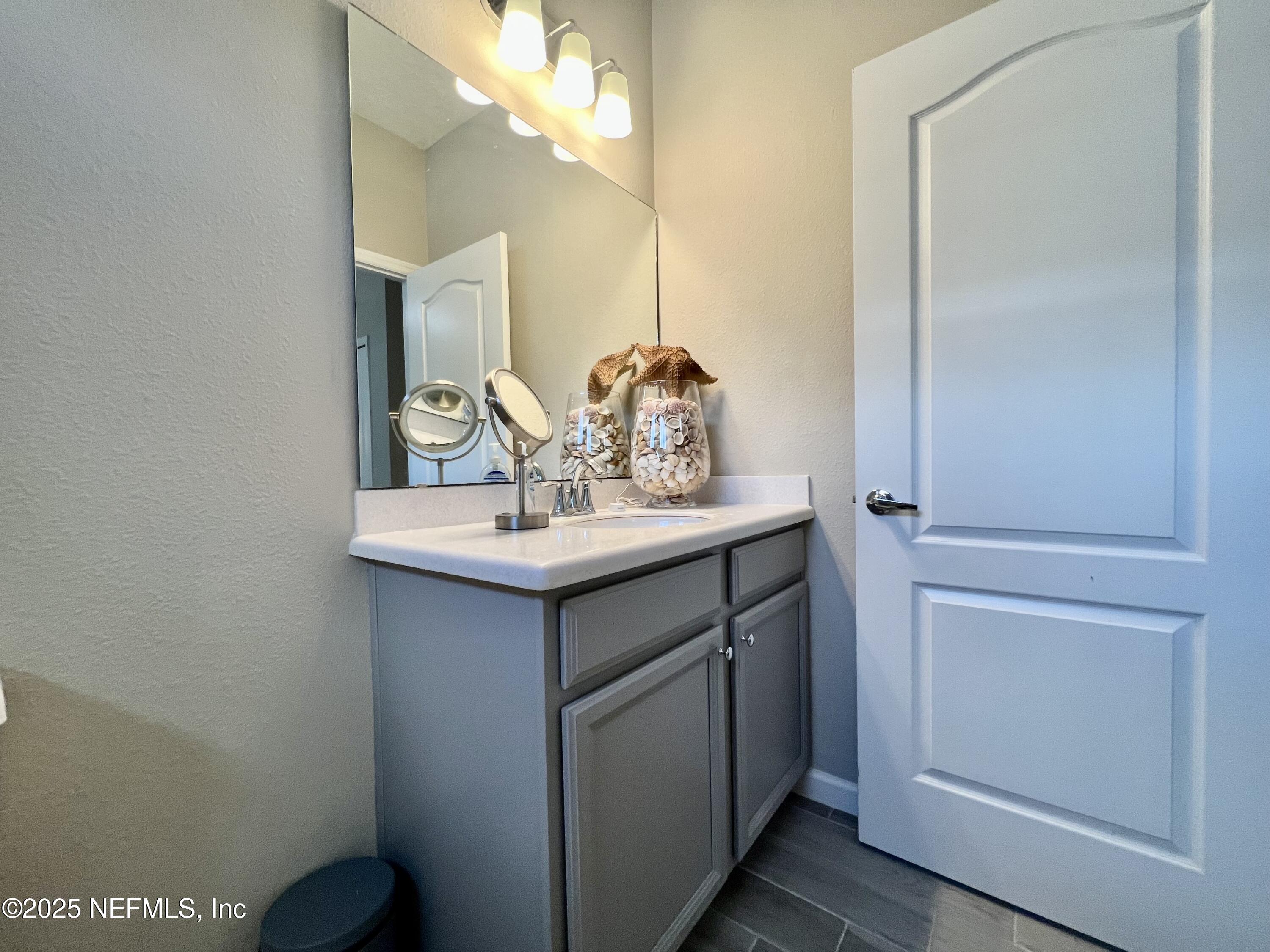 128 Ash Breeze Cove St. Augustine, FL 32095 - Photo 29 of 57 a bathroom with a sink and a mirror