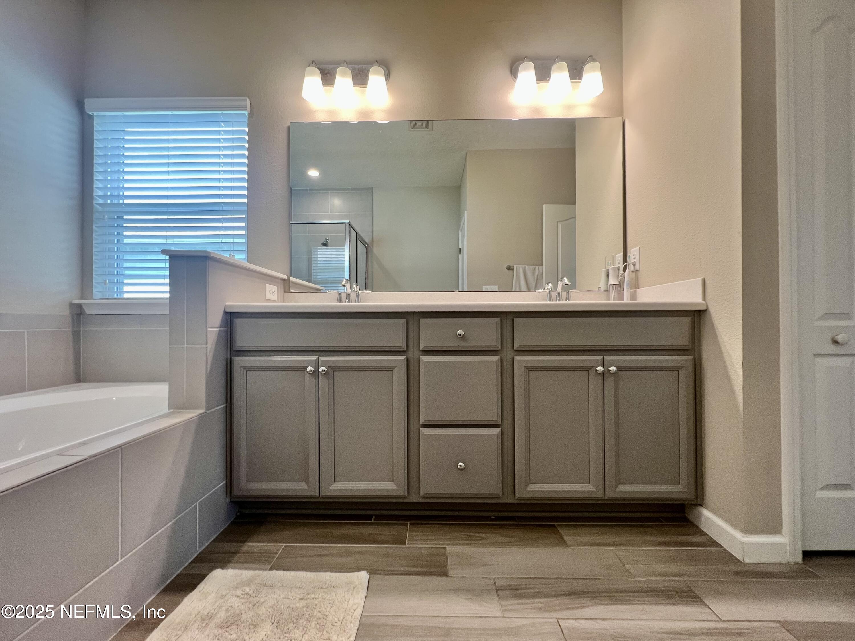 128 Ash Breeze Cove St. Augustine, FL 32095 - Photo 33 of 57 a bathroom with a sink and a mirror
