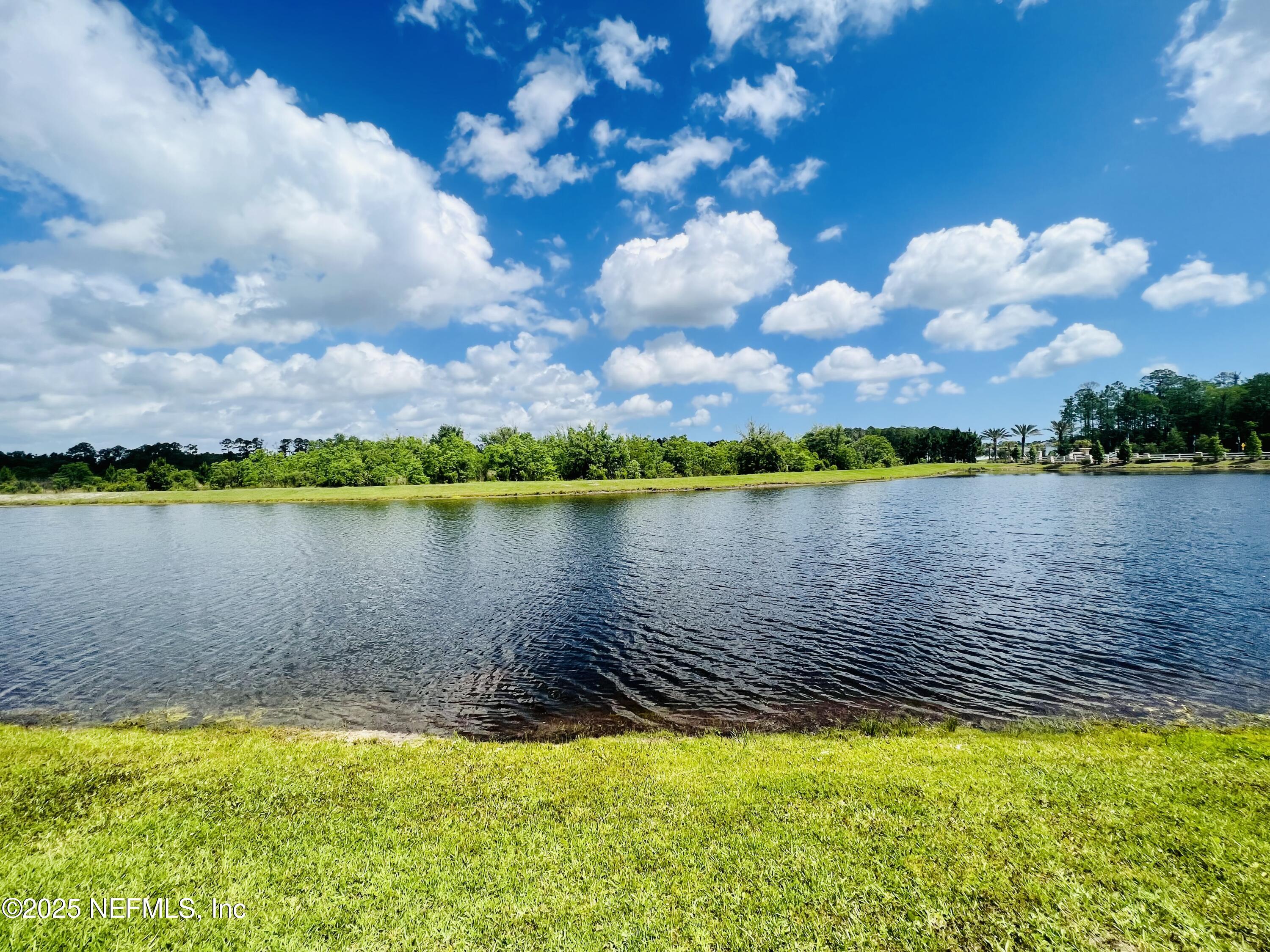 128 Ash Breeze Cove St. Augustine, FL 32095 - Photo 40 of 57 a view of a lake with houses in the back