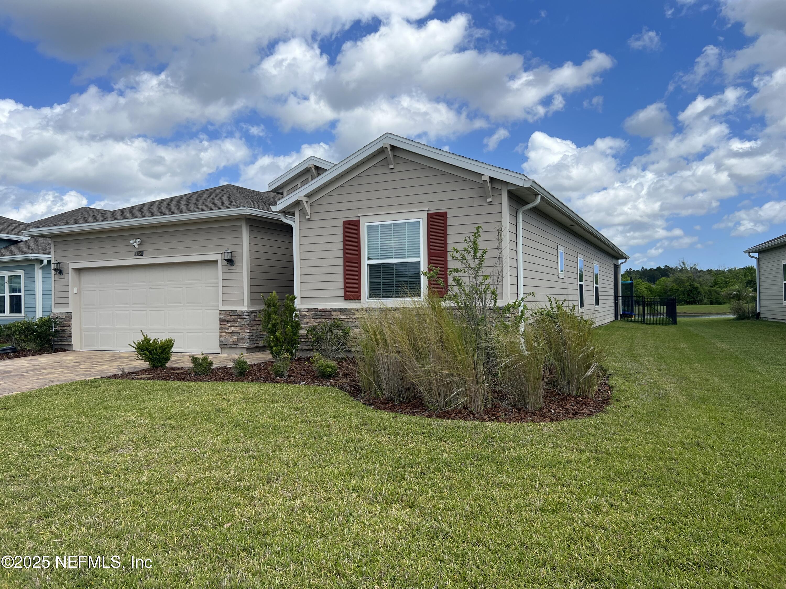 128 Ash Breeze Cove St. Augustine, FL 32095 - Photo 4 of 57 a view of a house with backyard and garden