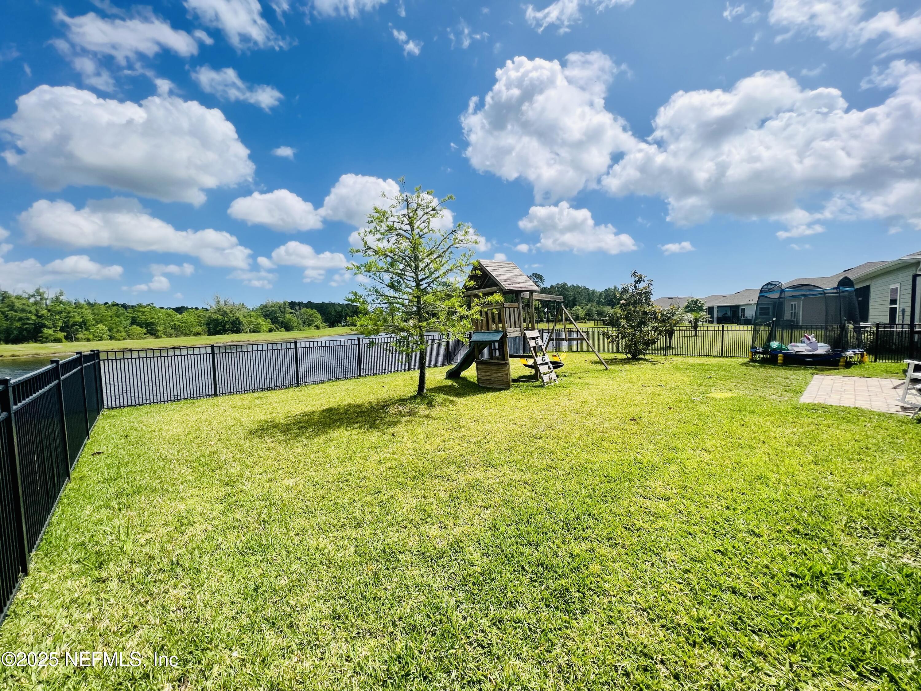 128 Ash Breeze Cove St. Augustine, FL 32095 - Photo 43 of 57 a swimming pool with outdoor seating and garden