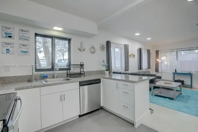 a kitchen with sink stove and cabinets