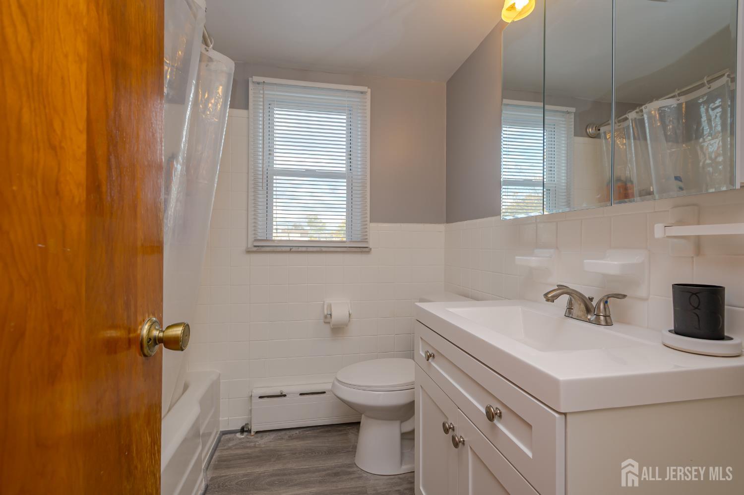10 Mary Avenue Fords, NJ 08863 - Photo 17 of 23 a bathroom with a sink a toilet and a mirror
