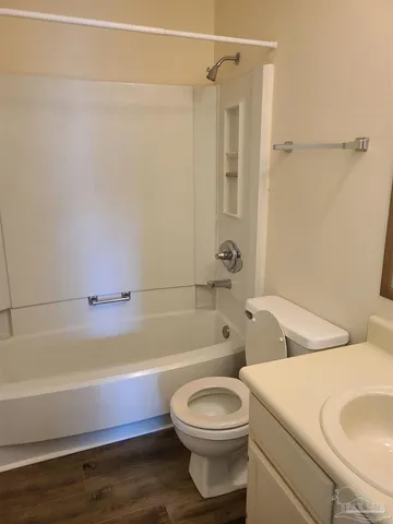 a bathroom with a toilet and a bath tub
