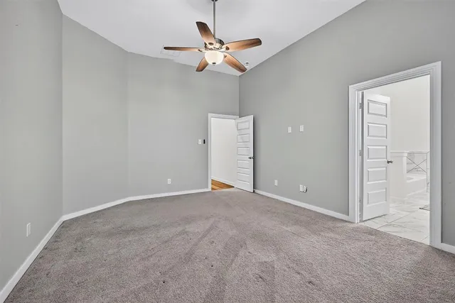 a view of a livingroom with a ceiling fan and window