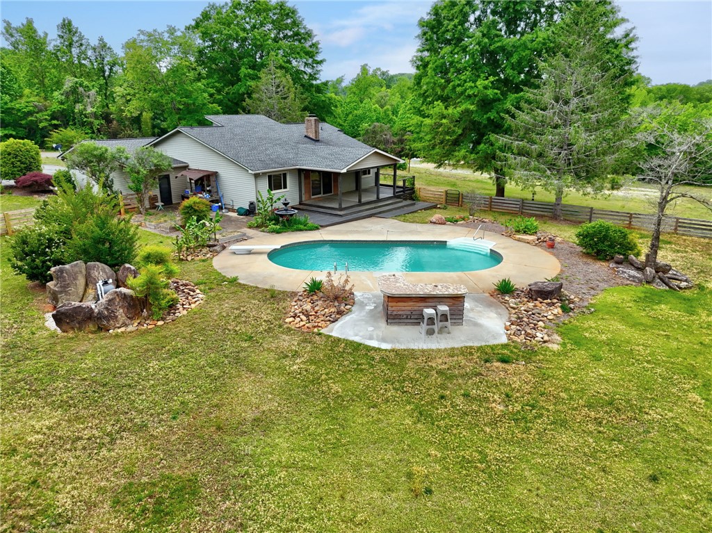433 Latham Road Easley, SC 29640 - Photo 47 of 50 A private pool with a custom bar area awaits, surrounded by verdant landscaping.