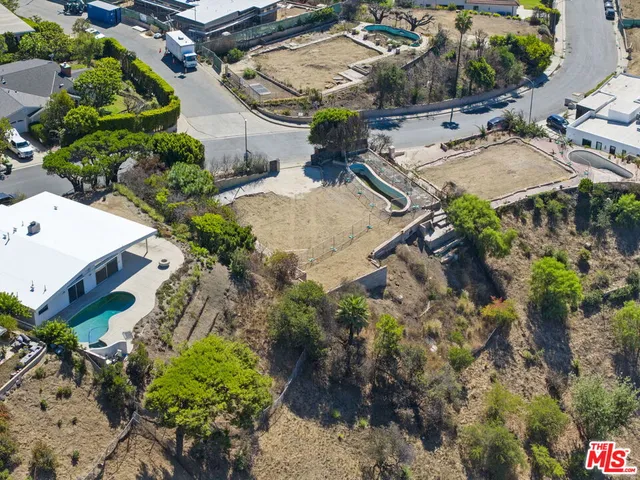 an aerial view of a house with yard