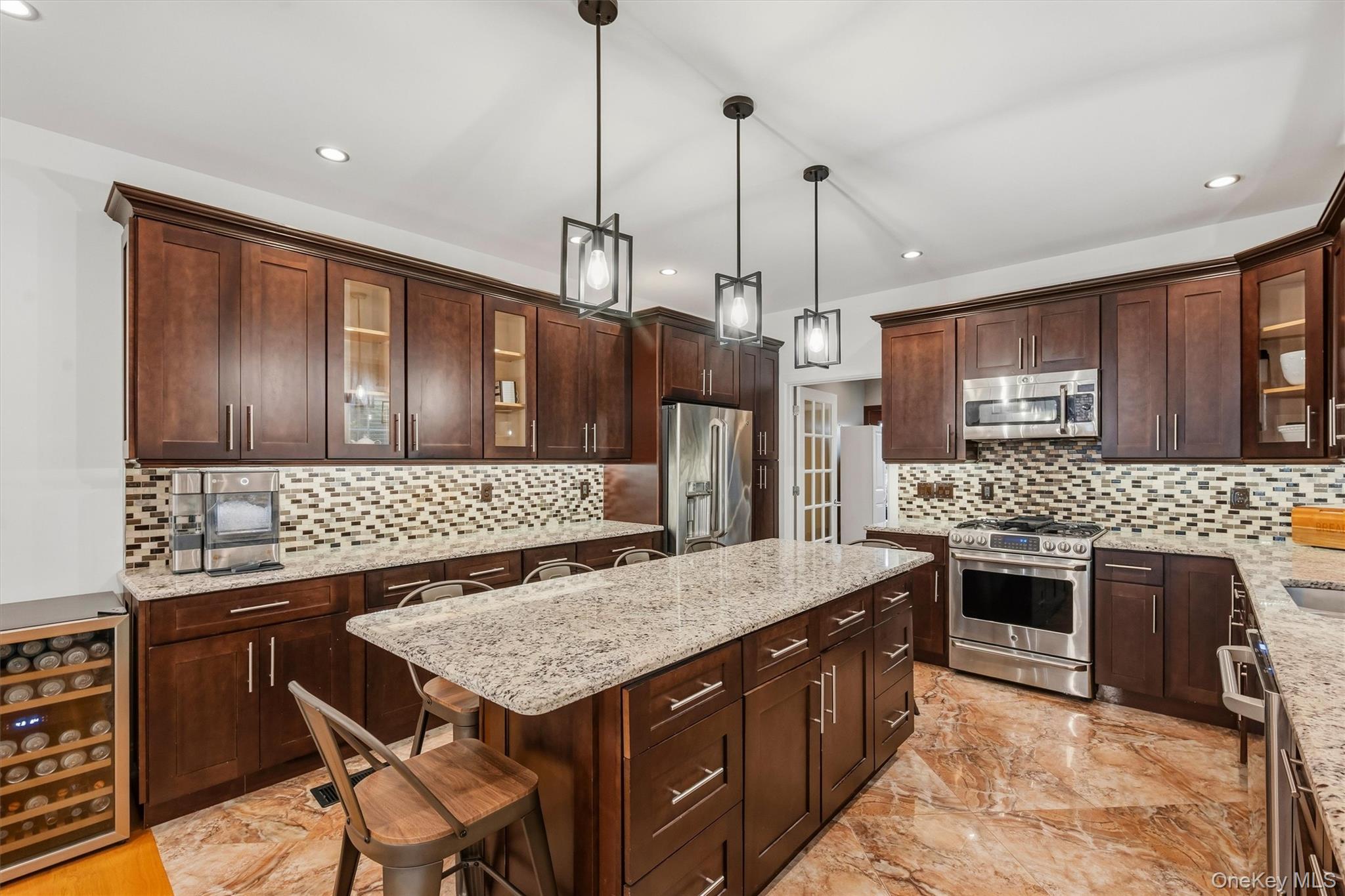 8 Darmstadter Road Bloomingburg, NY 12721 - Photo 20 of 47 Kitchen with 7 foot 7 inch center island that seats 6, Anderson casement window above sink, Cafe appliances, granite countertops, tile backsplash, uplighting, Recessed lighting, marble tile floors and 9 foot ceilings.