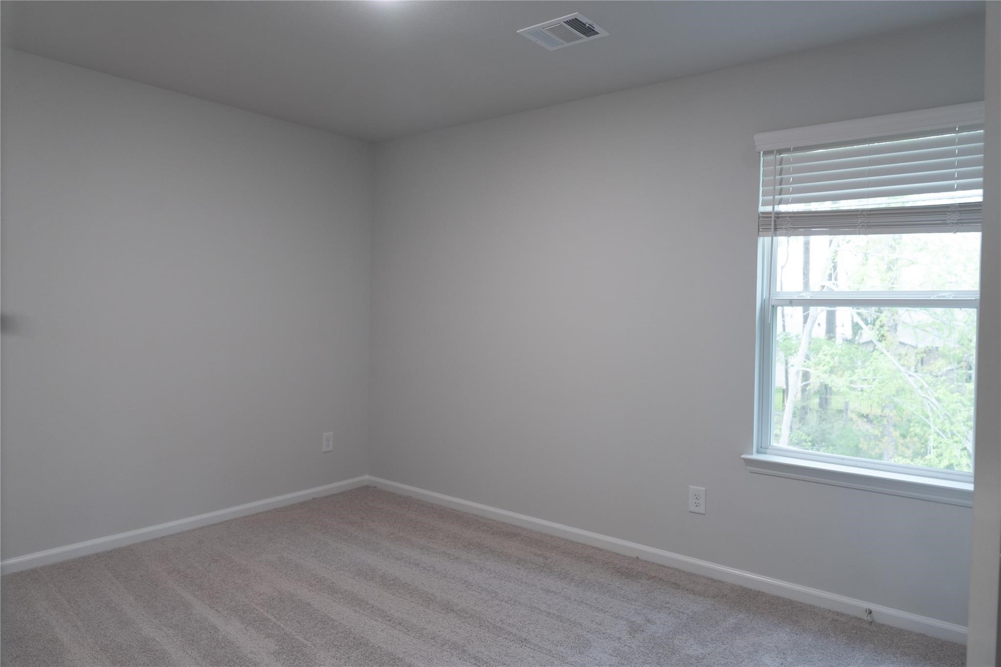 64 Valiant Ridge Trail Magnolia, TX 77354 - Photo 15 of 33 an empty room with a window