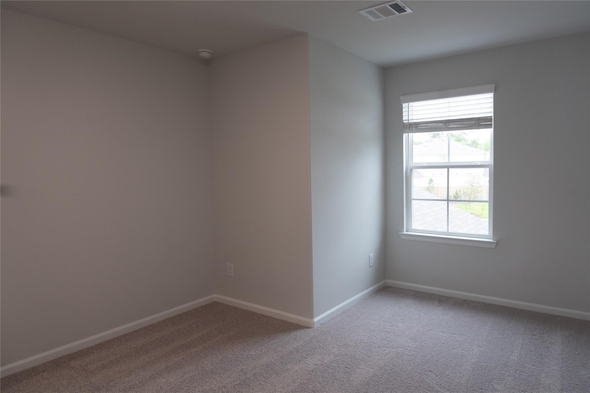 64 Valiant Ridge Trail Magnolia, TX 77354 - Photo 25 of 33 an empty room with a window