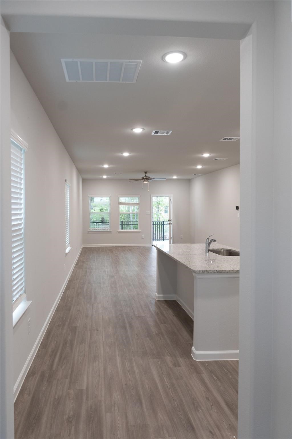 64 Valiant Ridge Trail Magnolia, TX 77354 - Photo 28 of 33 a view of kitchen and kitchen with a sink wooden floor and windows