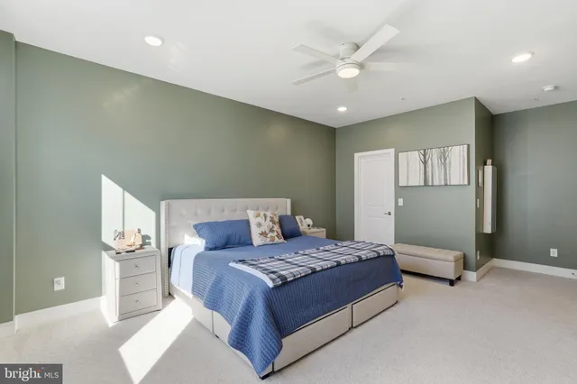 a bedroom with a large bed and a chandelier