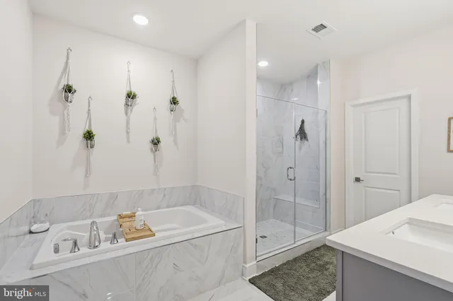 a bathroom with a sink vanity and shower