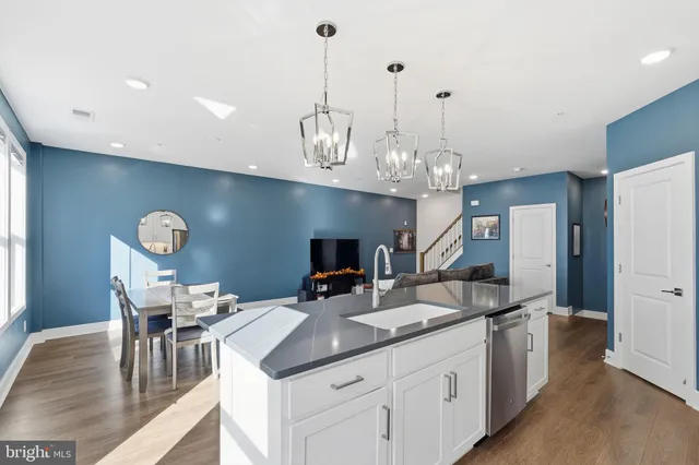 a open kitchen with sink and refrigerator