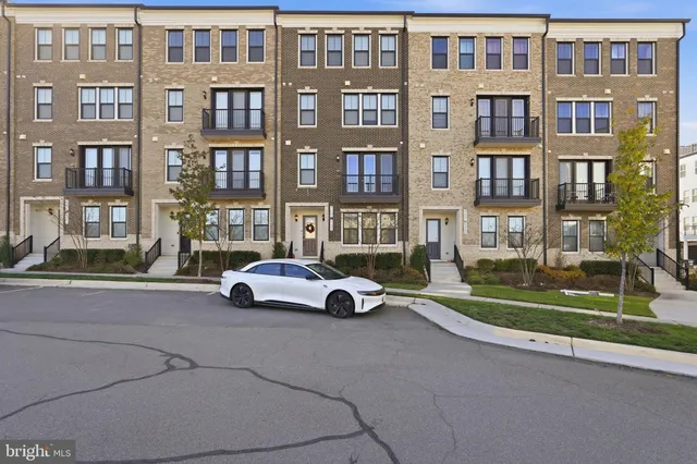 a city street lined with buildings and a yard