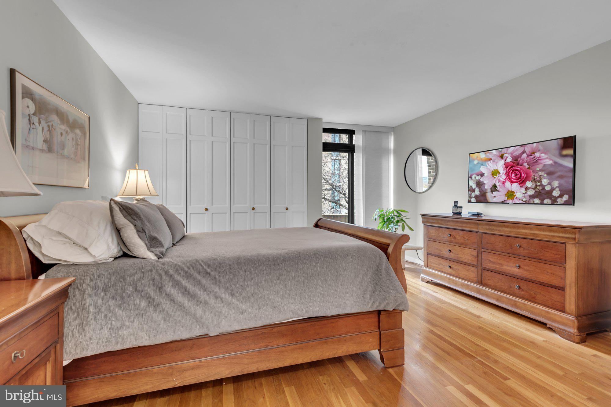 1263 Delaware Avenue Southwest, Unit 53 Washington, DC 20024 - Photo 20 of 65 Primary Bedroom w/wood floors and wall of closets
