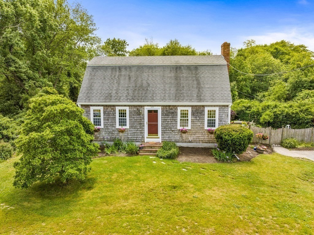 a view of a house with pool and a yard