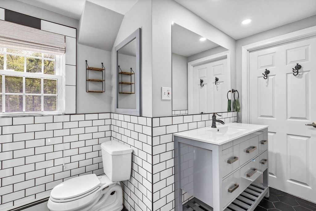 207 Tilden Road Scituate, MA 02066 - Photo 17 of 34 a bathroom with a sink a toilet and mirror